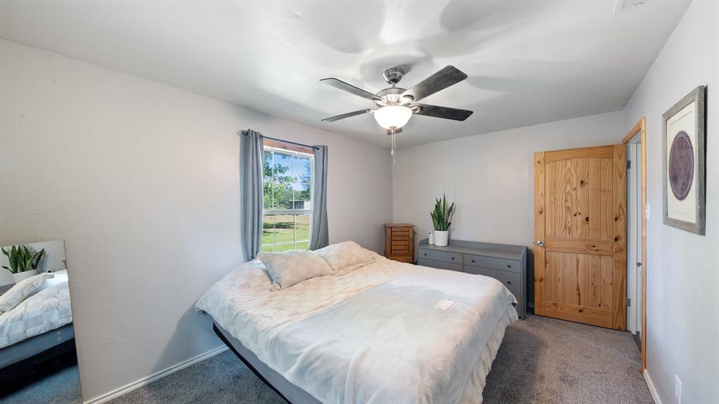 29080 Highway 19 Athens, TX 75752 - Photo 15 of 30 a bedroom with a bed and a chandelier