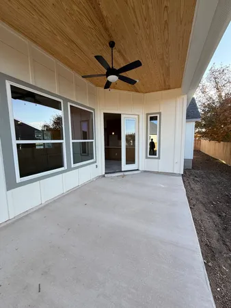 a view of a porch with a ceiling fan and window