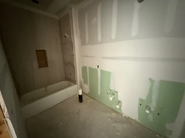 a living room with stainless steel appliances kitchen island granite countertop furniture and fireplace