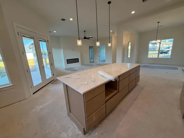 a view of a livingroom with a ceiling fan and window