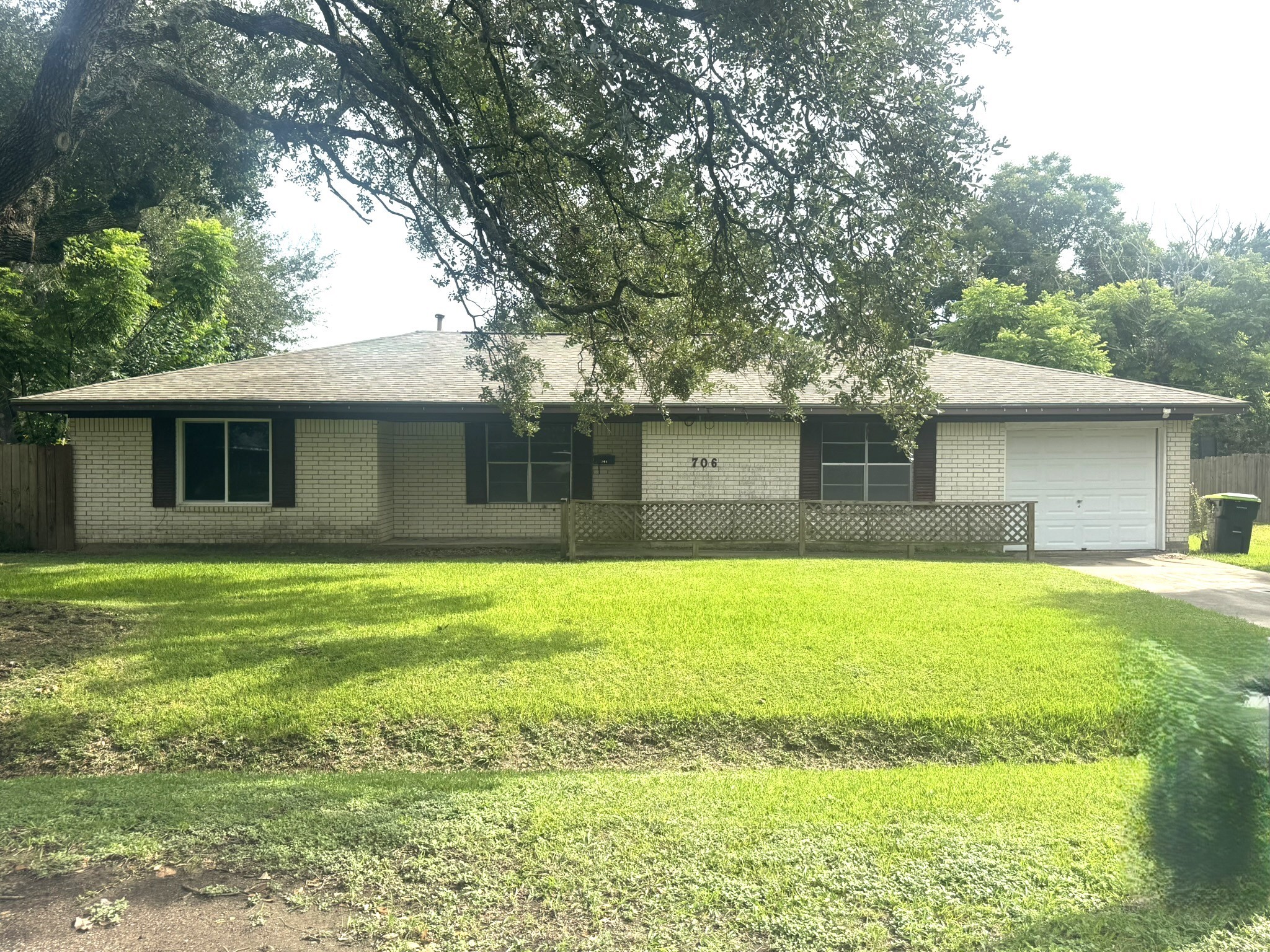 706 University Avenue Wharton, TX 77488 - Photo 1 of 29 a front view of a house with a garden