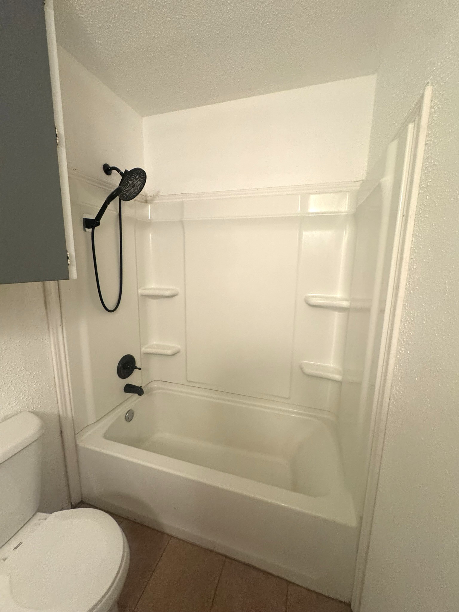 706 University Avenue Wharton, TX 77488 - Photo 14 of 29 a bathroom with a granite countertop bathtub shower sink vanity and toilet