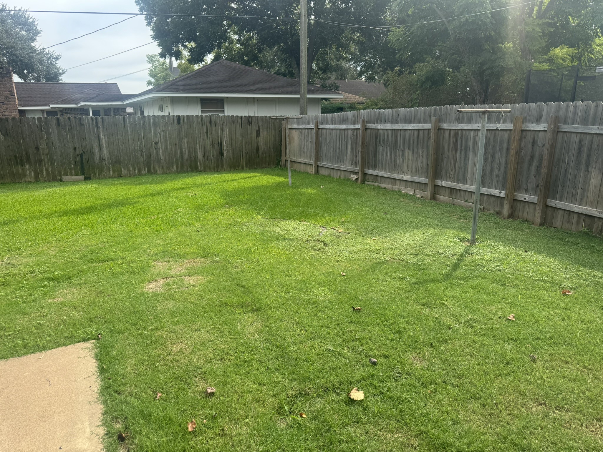 706 University Avenue Wharton, TX 77488 - Photo 24 of 29 a view of a backyard with a fence