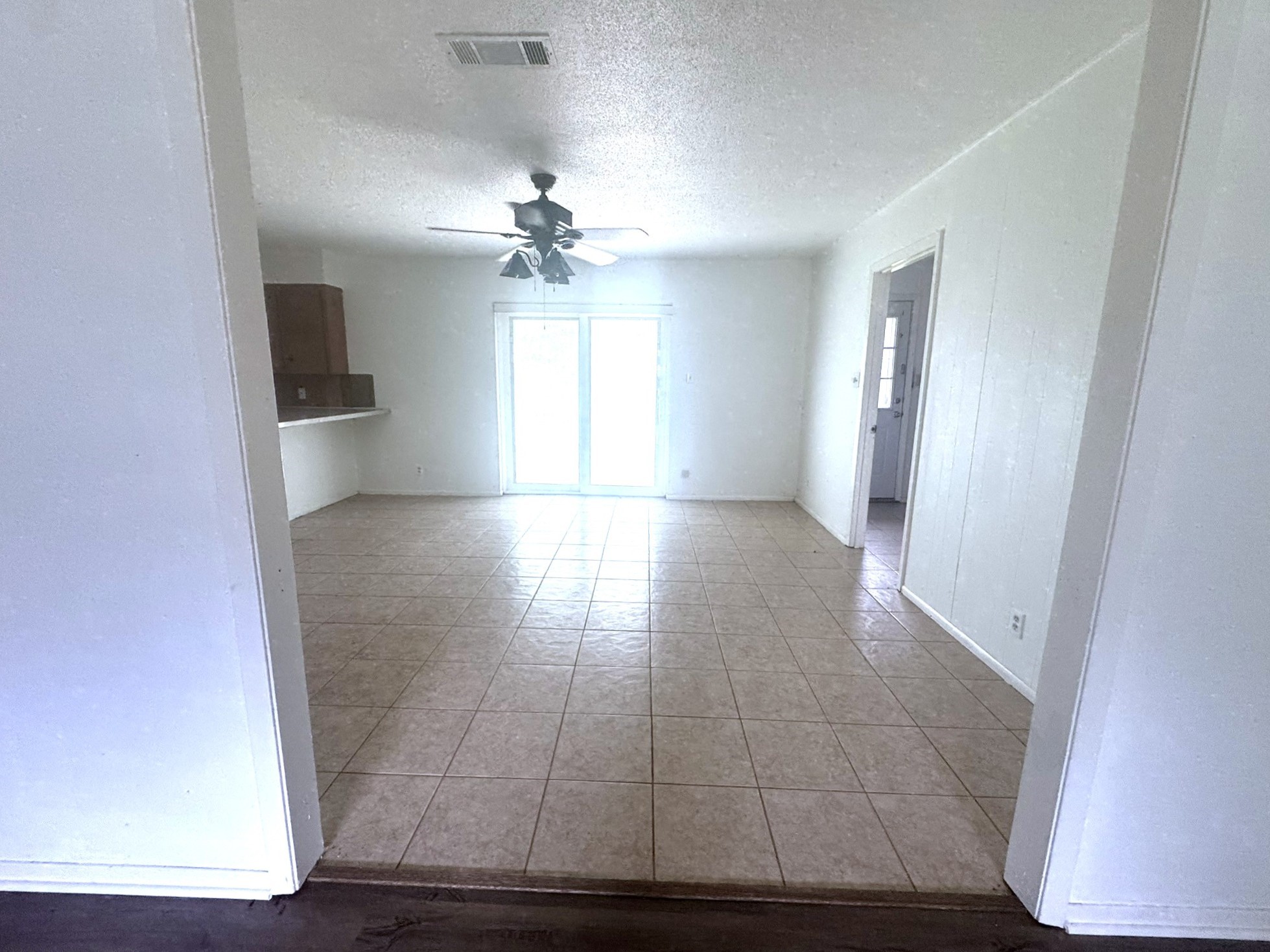 706 University Avenue Wharton, TX 77488 - Photo 4 of 29 wooden floor in an empty room with a window