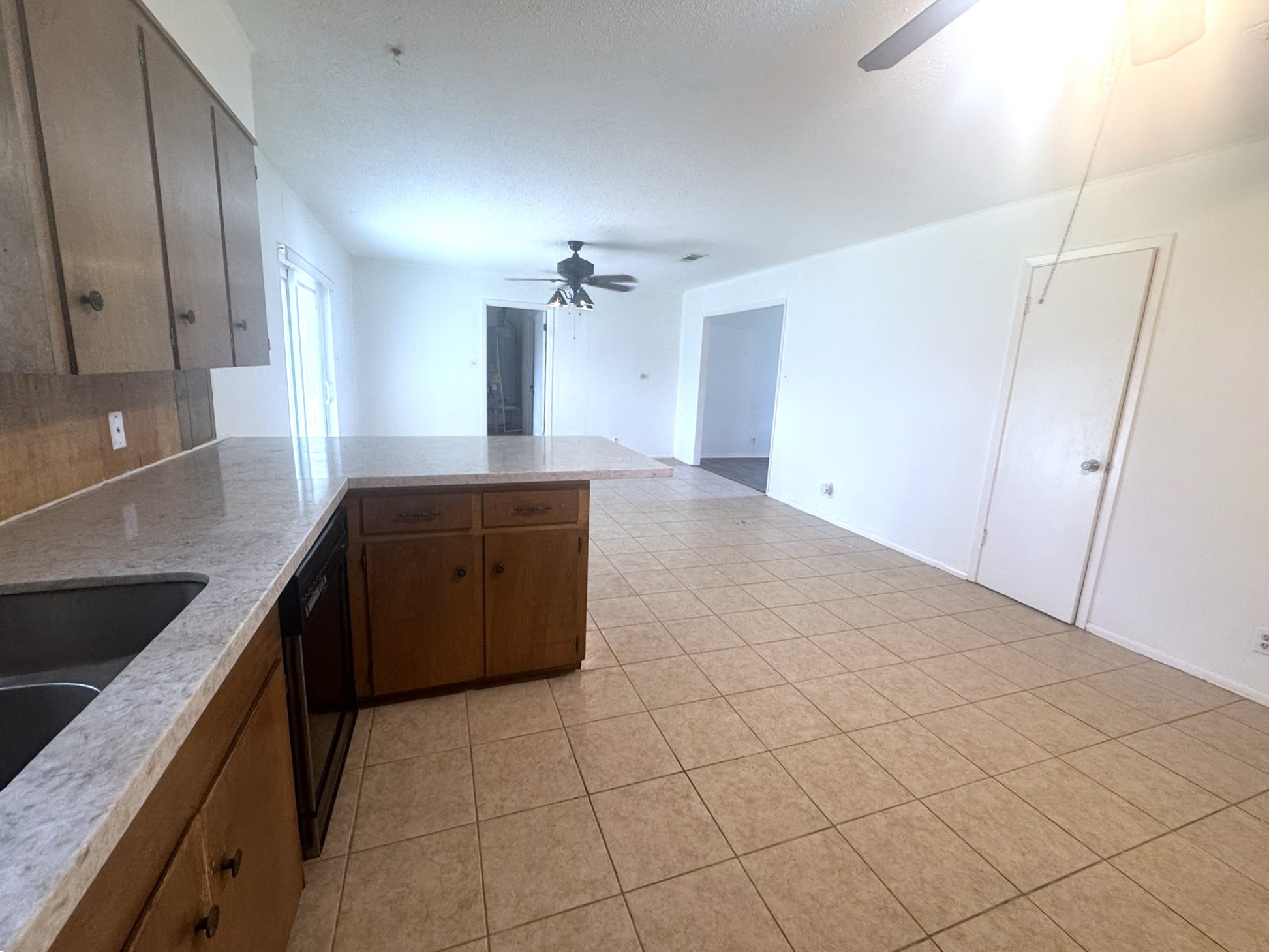 706 University Avenue Wharton, TX 77488 - Photo 6 of 29 a kitchen with granite countertop a sink and cabinets