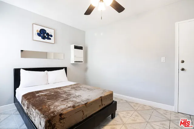 a bedroom with a bed dresser and a window