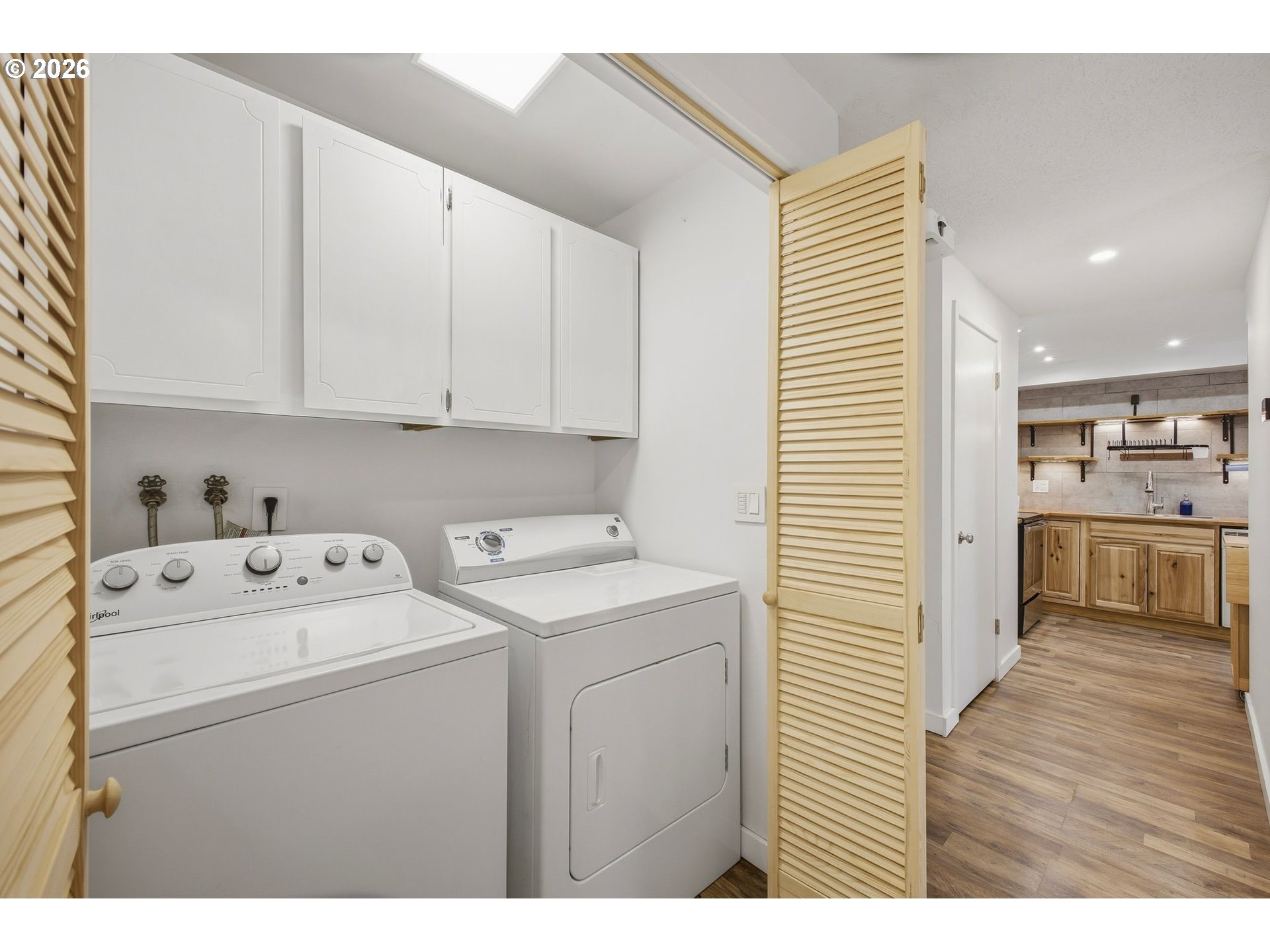 21858 Southwest Regal Court Beaverton, OR 97003 - Photo 17 of 29 a view of washer and dryer with kitchen countertops