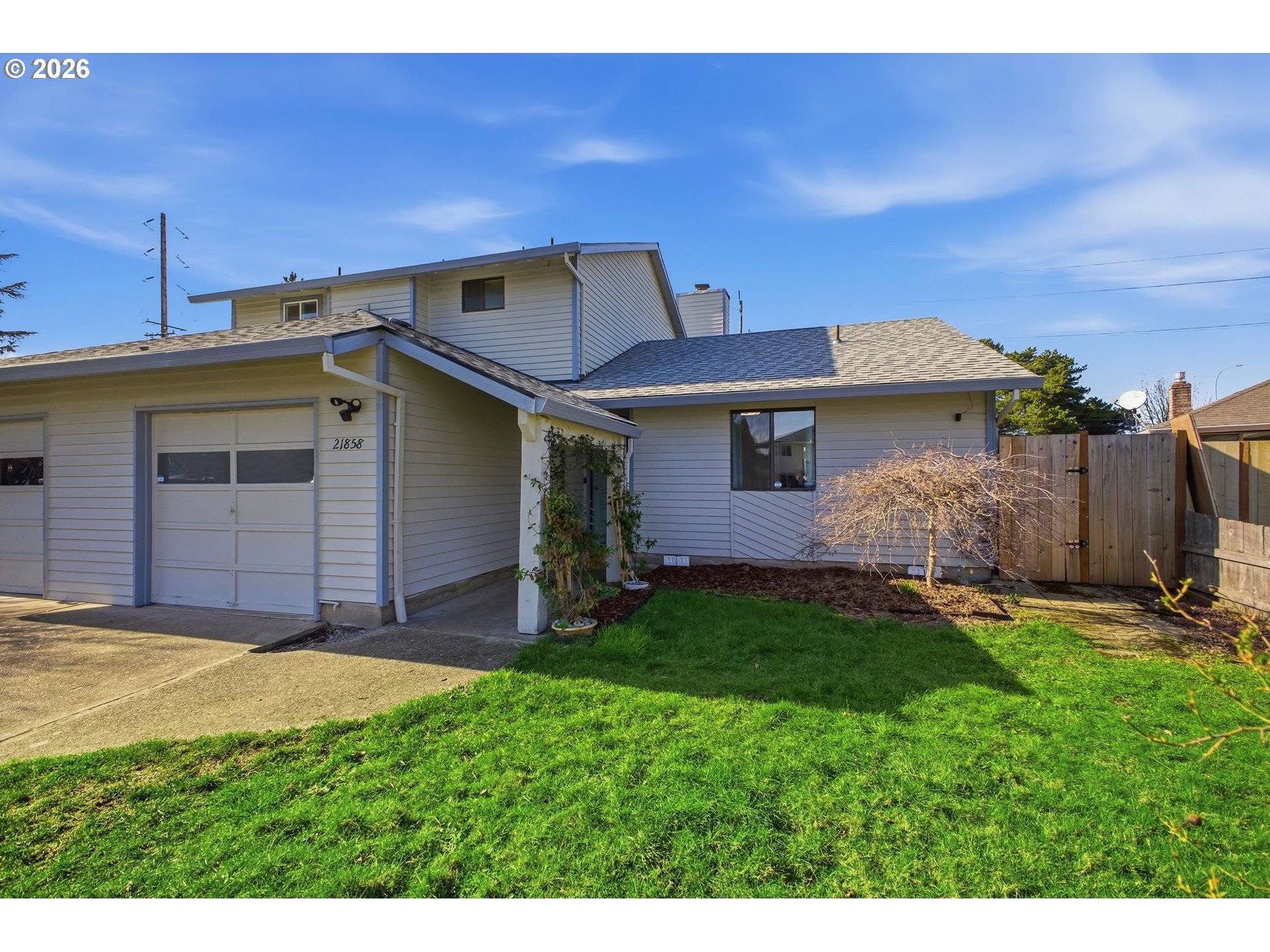 21858 Southwest Regal Court Beaverton, OR 97003 - Photo 2 of 29 a view of a house with a yard and garage