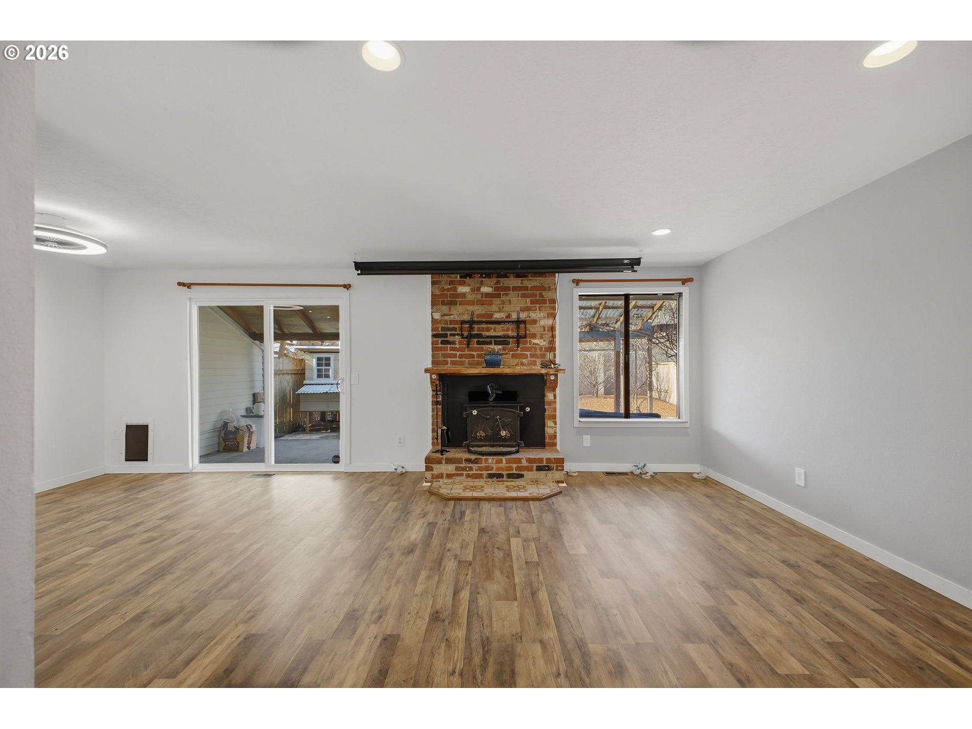 21858 Southwest Regal Court Beaverton, OR 97003 - Photo 7 of 29 a view of an empty room with a fireplace and window