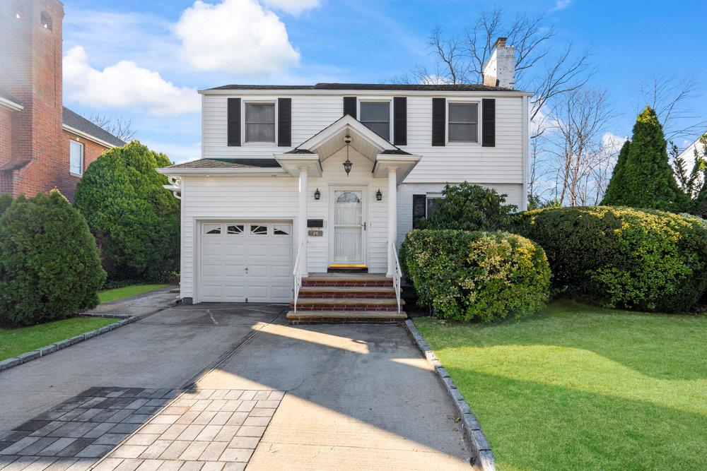 26 Steamboat Road Great Neck, NY 11024 - Photo 1 of 1 a front view of a house with a garden