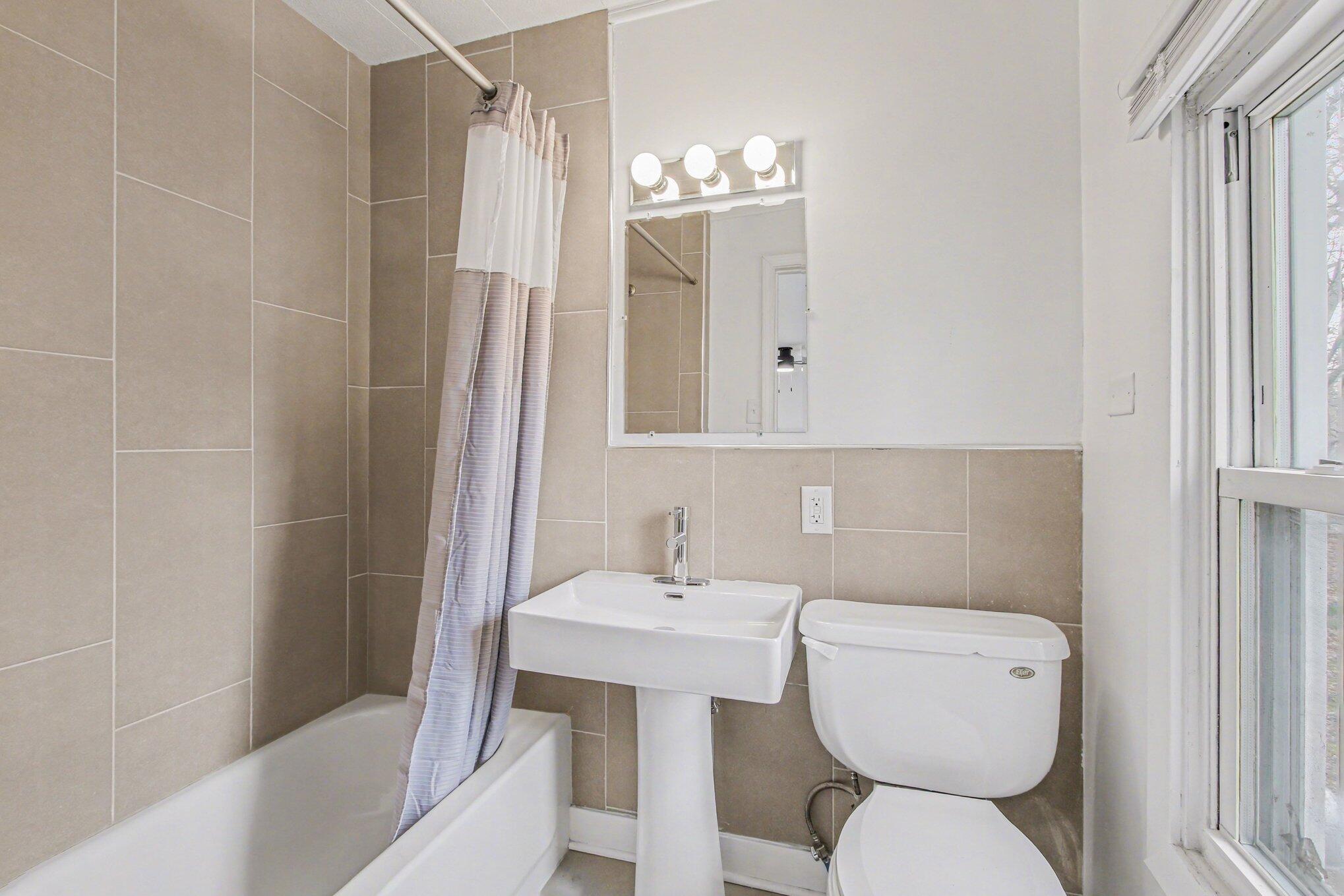 4471 Massachusetts Street Gary, IN 46409 - Photo 13 of 24 a bathroom with a toilet a sink and mirror