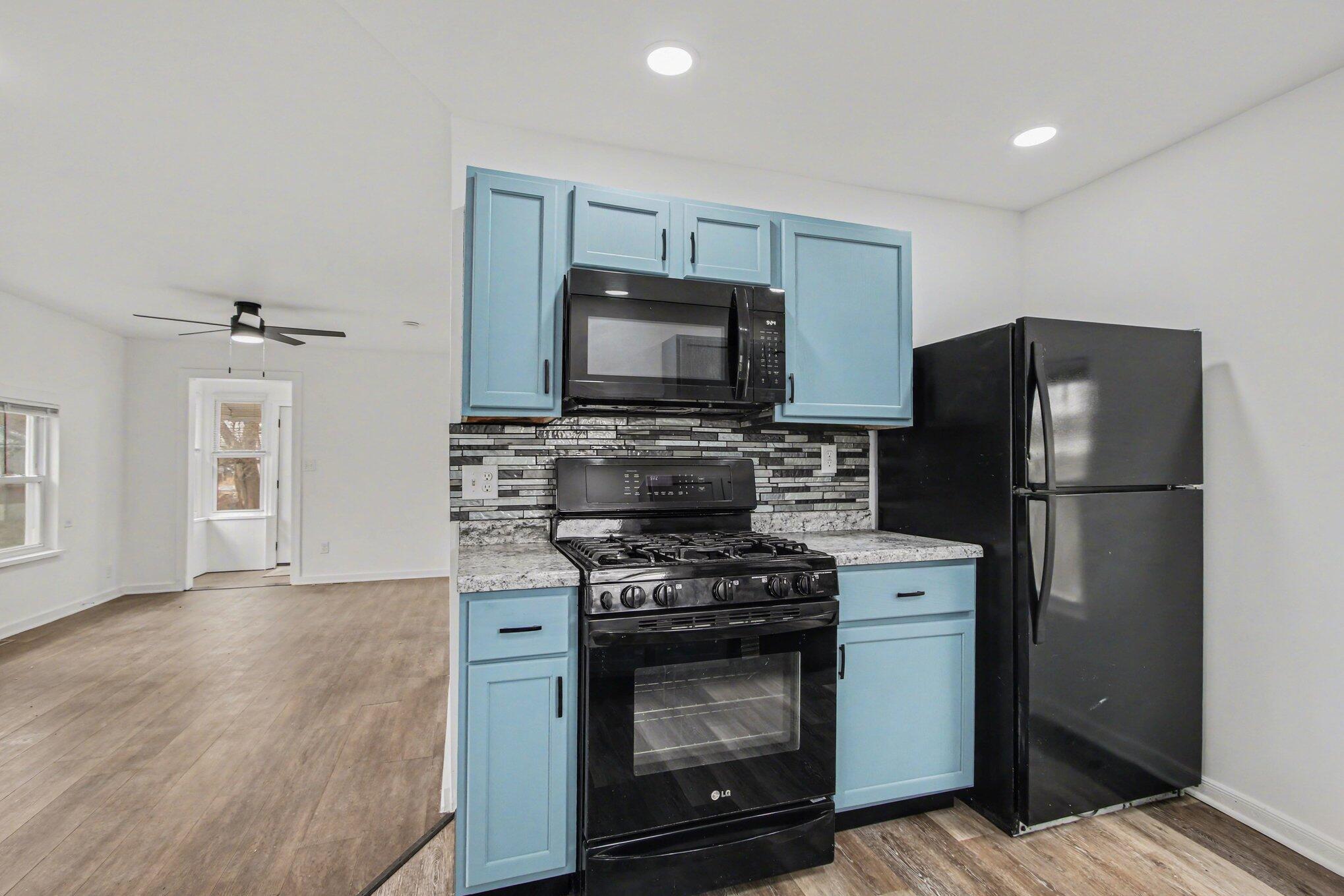 4471 Massachusetts Street Gary, IN 46409 - Photo 4 of 24 a kitchen with a stove microwave and refrigerator