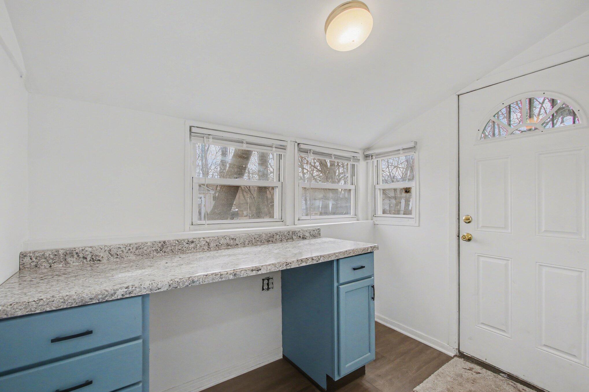 4471 Massachusetts Street Gary, IN 46409 - Photo 5 of 24 a kitchen with granite countertop a sink and a white cabinets