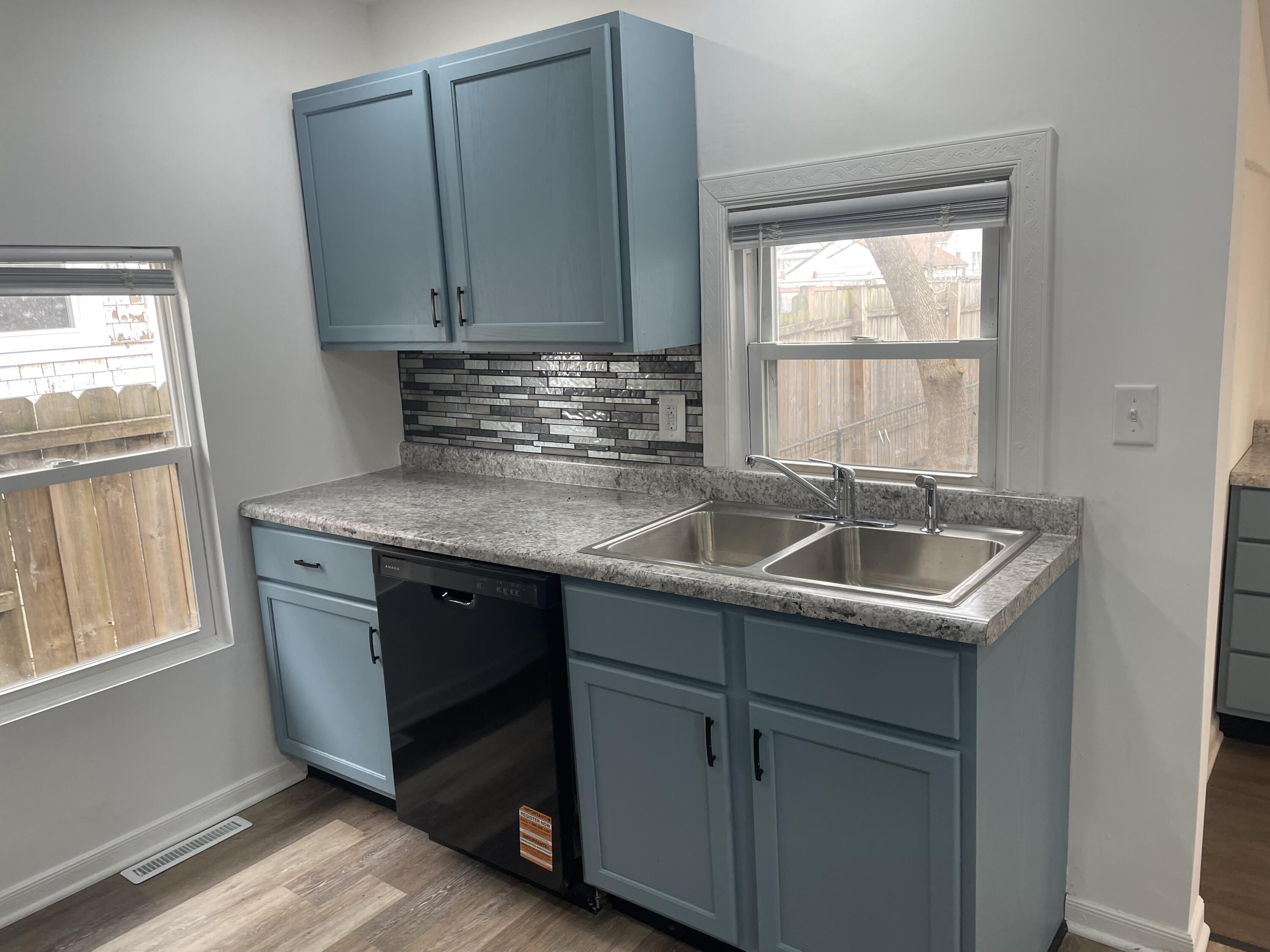 4471 Massachusetts Street Gary, IN 46409 - Photo 6 of 24 a kitchen with a sink stove and cabinets