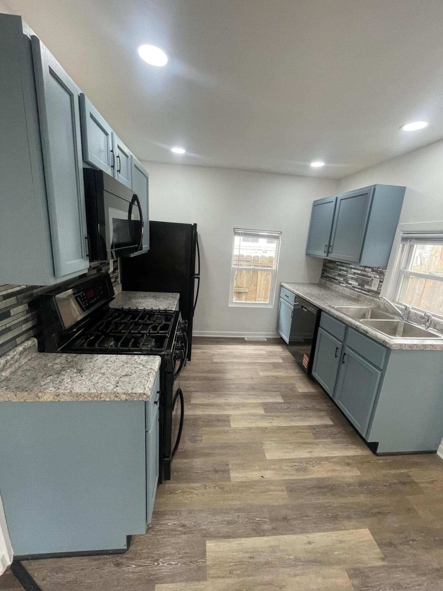 4471 Massachusetts Street Gary, IN 46409 - Photo 8 of 24 a kitchen with stainless steel appliances granite countertop a stove and a sink