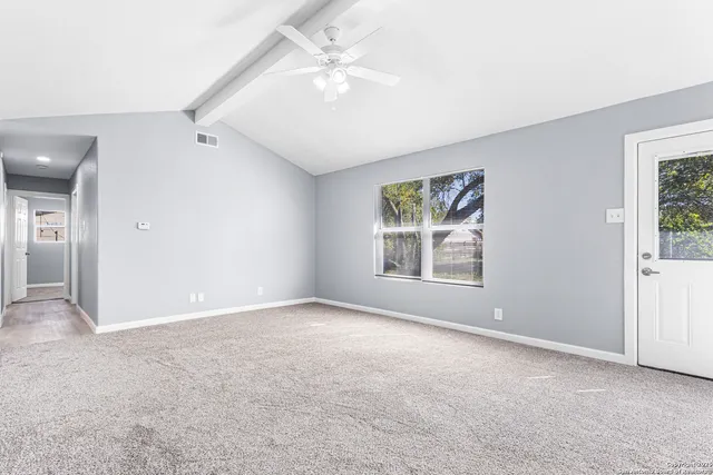 a view of an empty room with a window