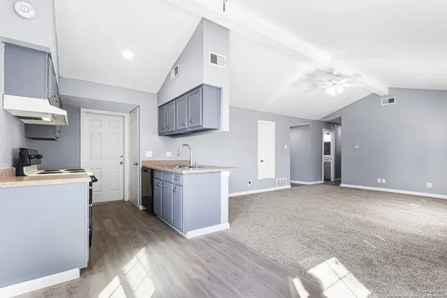 a kitchen with a stove a sink and a refrigerator