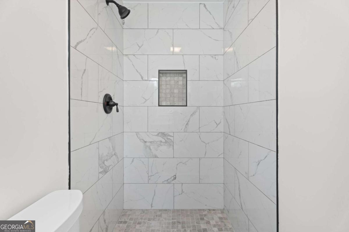 865 Old Tucker Road Stone Mountain, GA 30087 - Photo 32 of 57 a bathroom with a shower