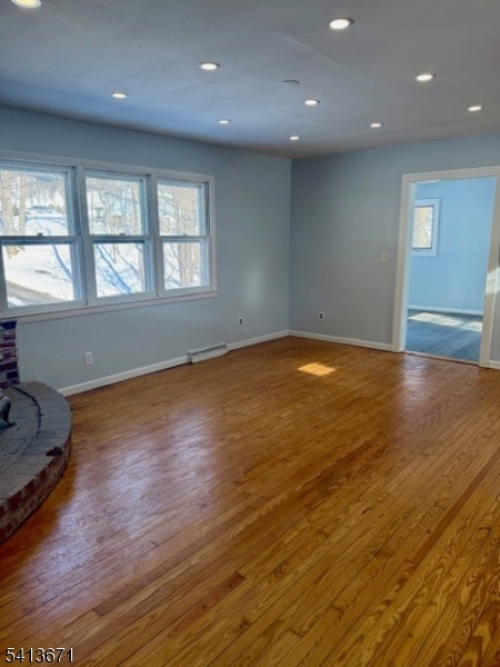 56 Appleseed Road Vernon, NJ 07461 - Photo 7 of 8 an empty room with wooden floor and windows