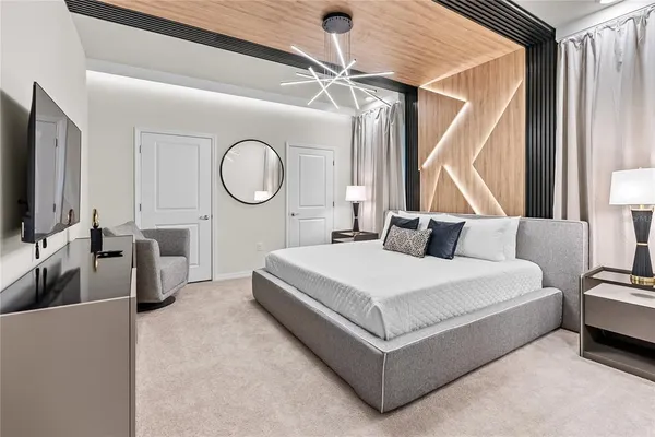 a bed room with a bed and a flat tv screen on a dresser