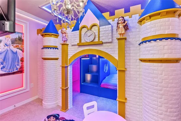 a view of a dining room with furniture and a chandelier