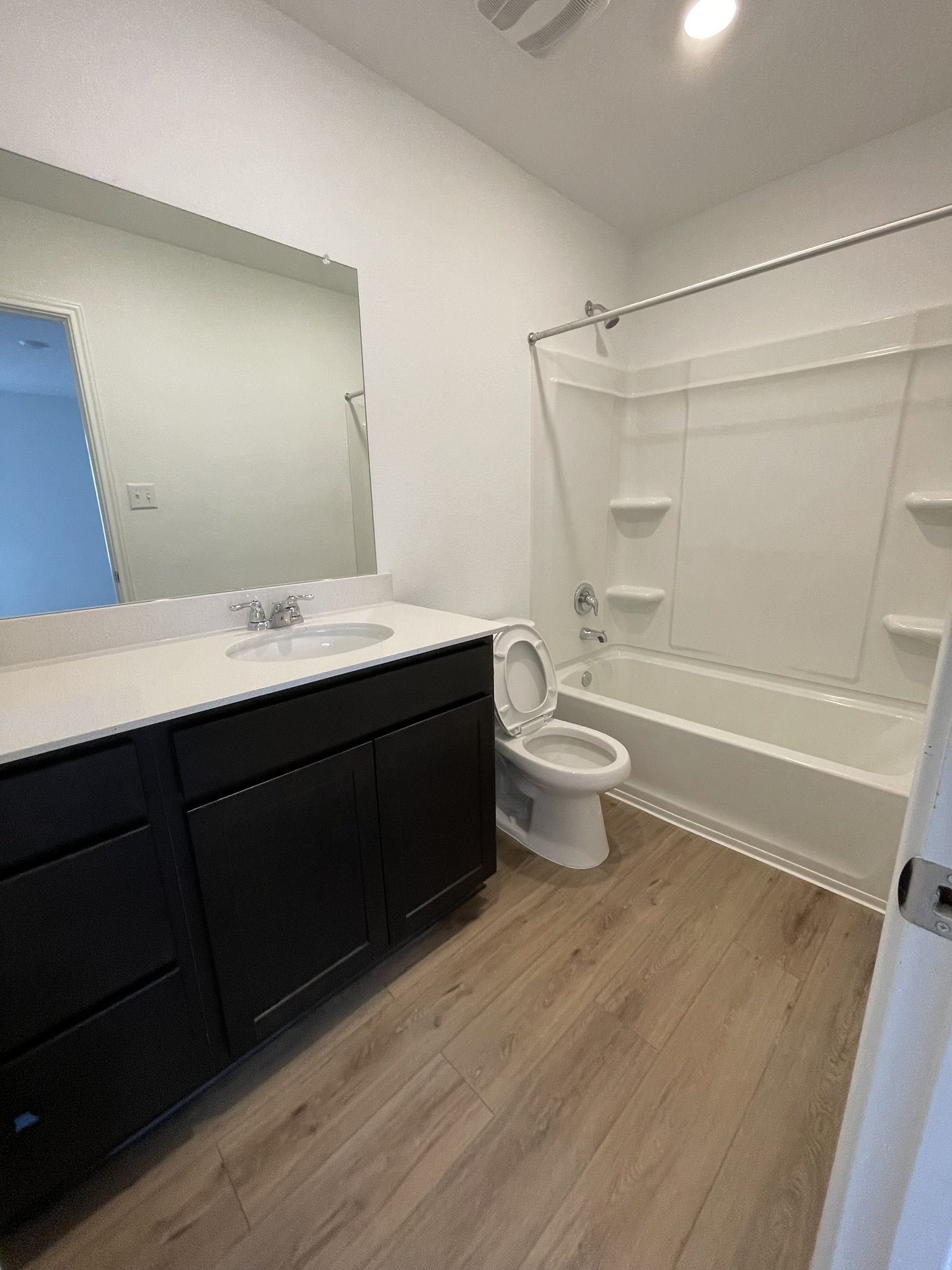 1121 Largemouth Lane Bastrop, TX 78602 - Photo 10 of 13 a bathroom with a sink a toilet a mirror and shower