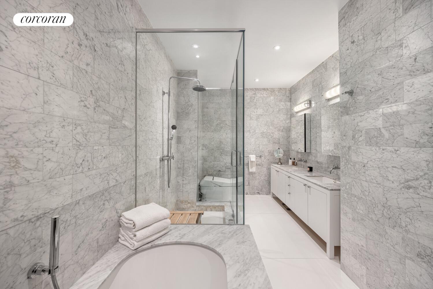 72 Mercer Street, Unit 5W Manhattan, NY 10012 - Photo 13 of 17 a large bathroom with a granite countertop sink a toilet a mirror and shower