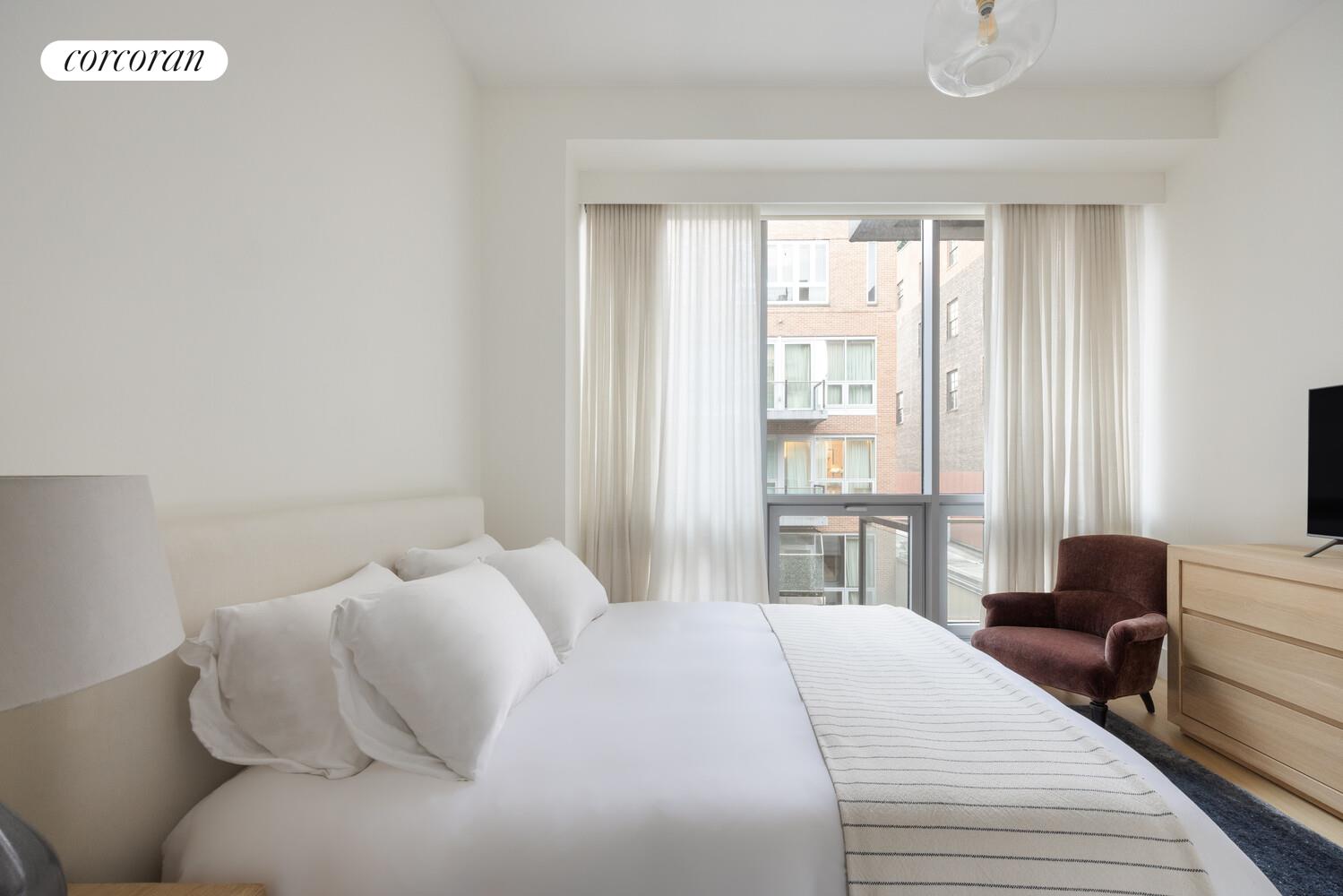 72 Mercer Street, Unit 5W Manhattan, NY 10012 - Photo 15 of 17 a bedroom with a bed and a large window