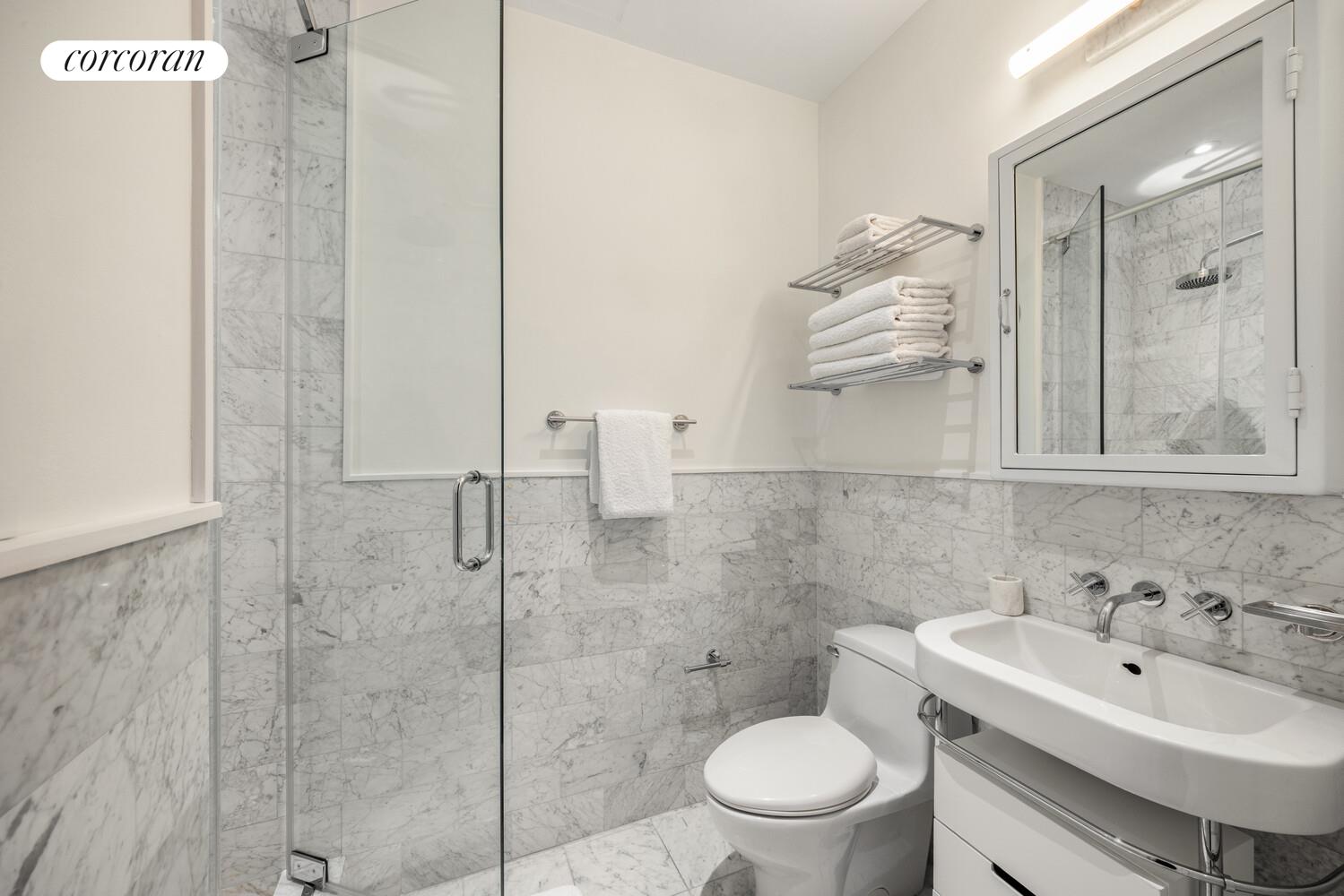 72 Mercer Street, Unit 5W Manhattan, NY 10012 - Photo 16 of 17 a bathroom with a sink toilet and shower