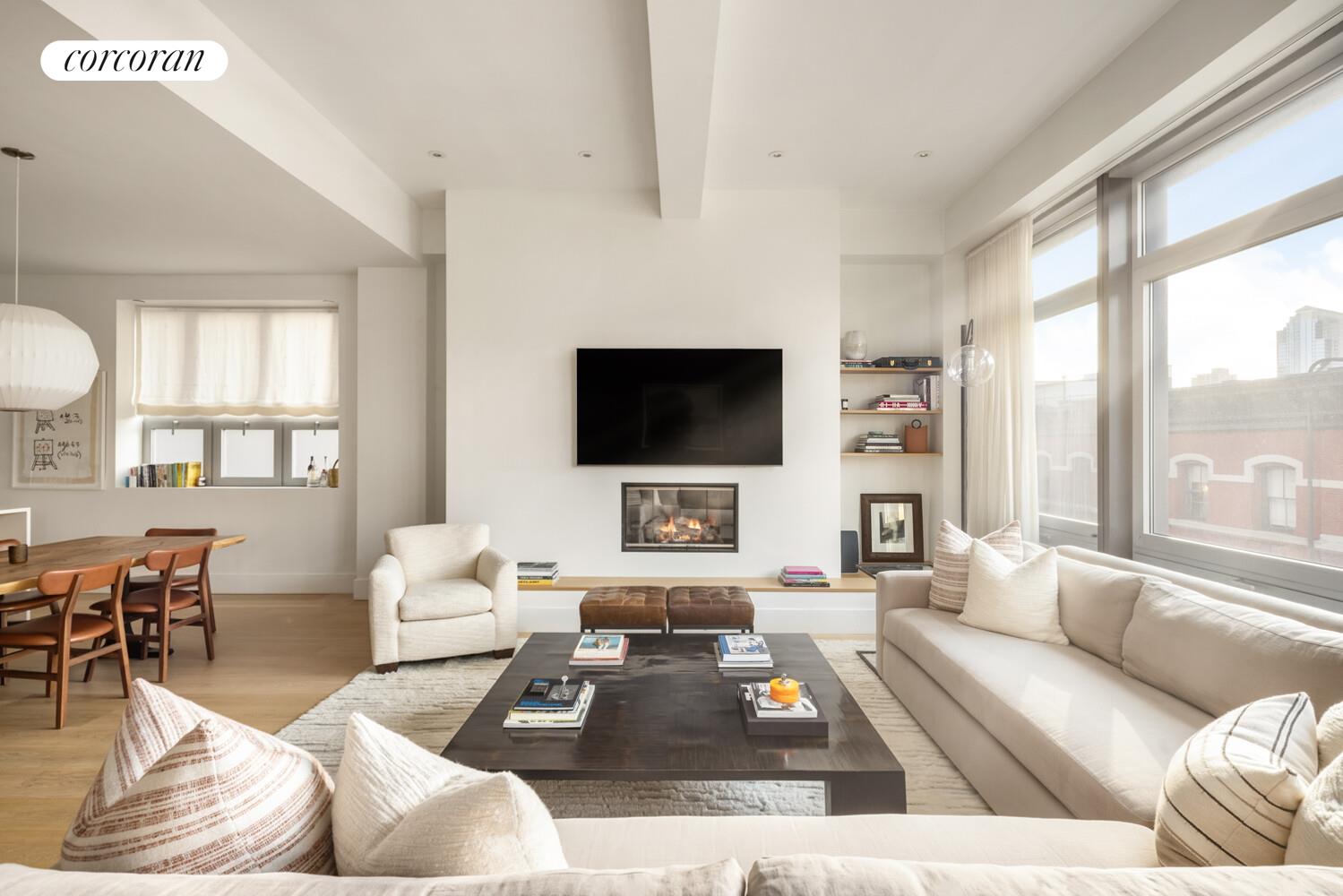 72 Mercer Street, Unit 5W Manhattan, NY 10012 - Photo 5 of 17 a living room with furniture a flat screen tv and a large window