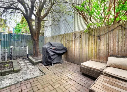 a view of a two chairs in the patio