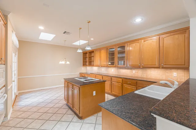 a kitchen with stainless steel appliances granite countertop a sink and a stove