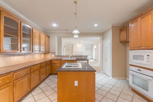 a kitchen with stainless steel appliances granite countertop a stove a sink and a refrigerator