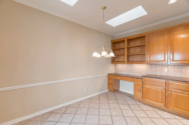 a view of a kitchen with a sink and cabinets