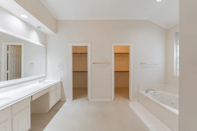 a bathroom with a tub sink and a mirror