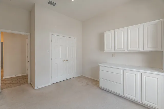a kitchen with white cabinets