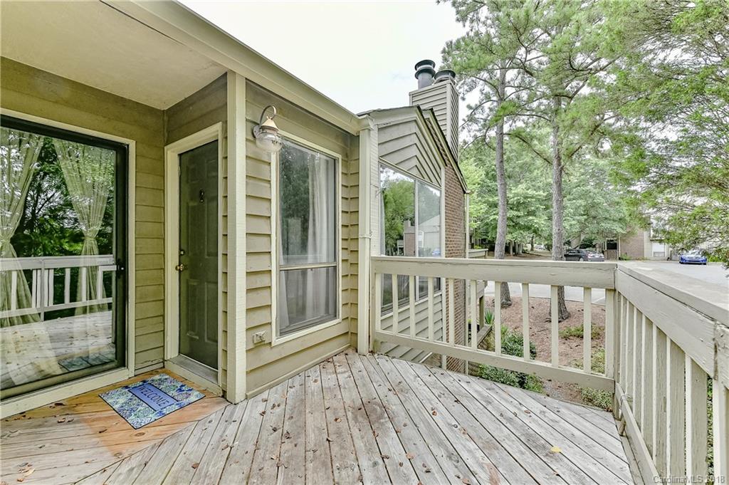 1606 Sharon Road West, Unit 34 Charlotte, NC 28210 - Photo 3 of 18 a view of a wooden deck and a yard