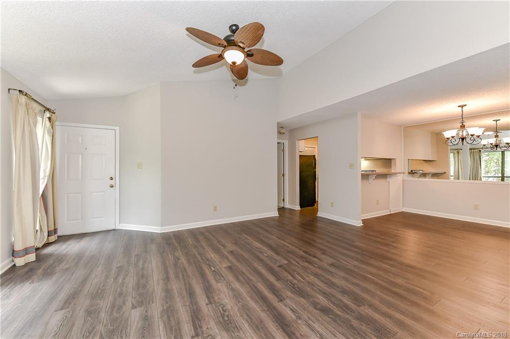 1606 Sharon Road West, Unit 34 Charlotte, NC 28210 - Photo 5 of 18 a view of empty room with wooden floor and ceiling fan