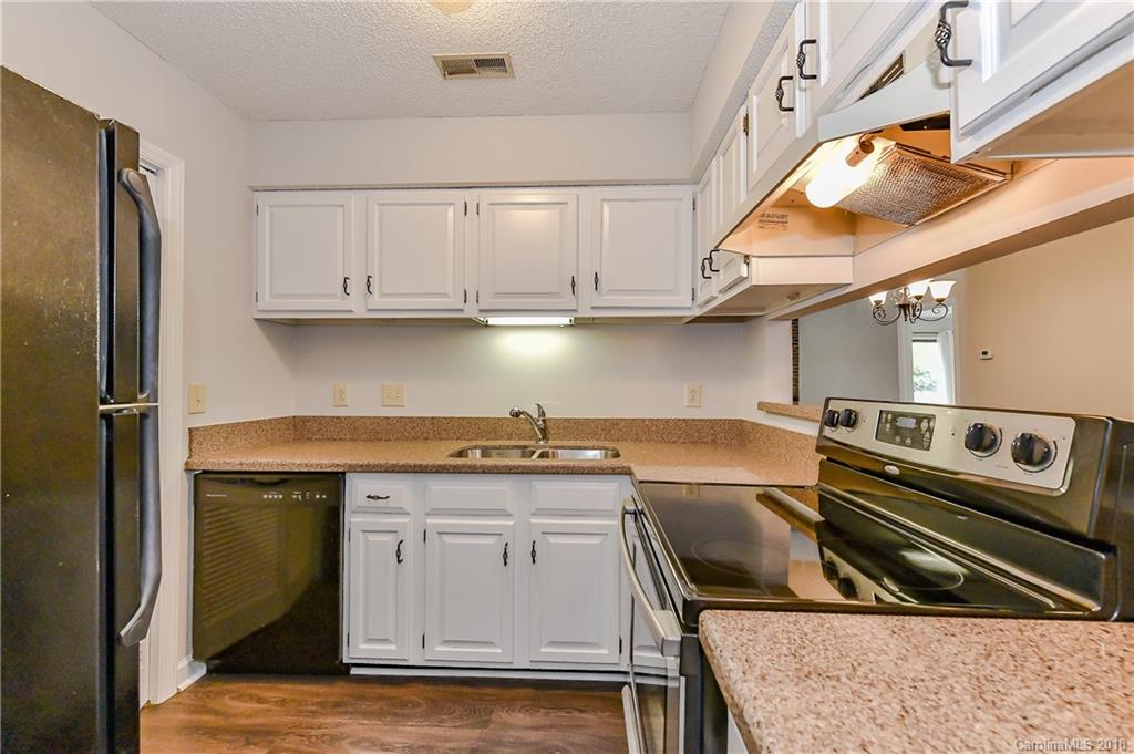 1606 Sharon Road West, Unit 34 Charlotte, NC 28210 - Photo 8 of 18 a kitchen with a stove and a refrigerator