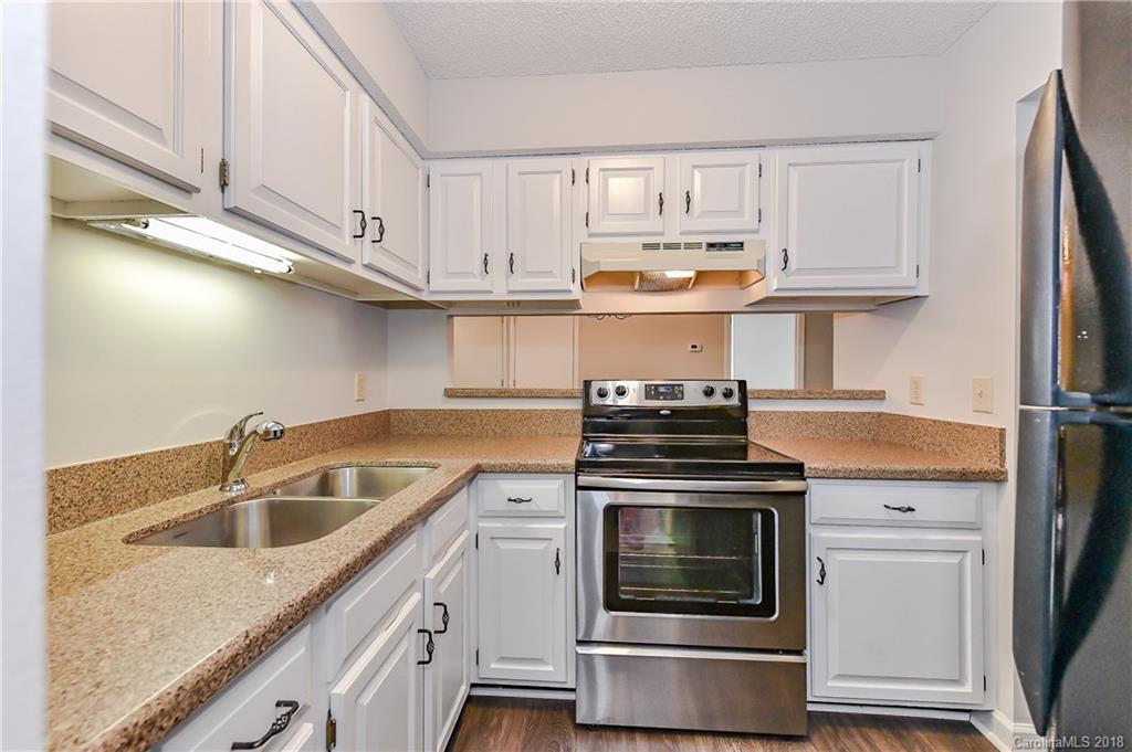 1606 Sharon Road West, Unit 34 Charlotte, NC 28210 - Photo 9 of 18 a kitchen with cabinets appliances and a sink
