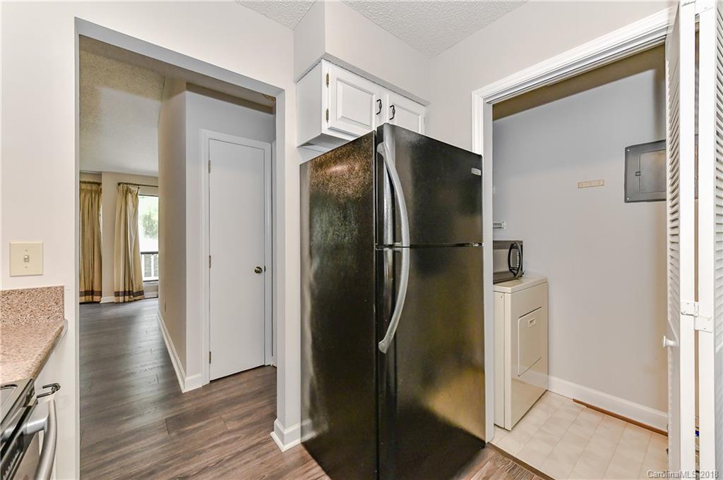 1606 Sharon Road West, Unit 34 Charlotte, NC 28210 - Photo 10 of 18 a room with wooden floor and a bathroom