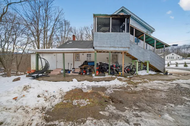a view of a house with snow on the road
