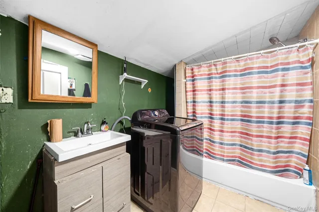 a bathroom with a sink a toilet and mirror