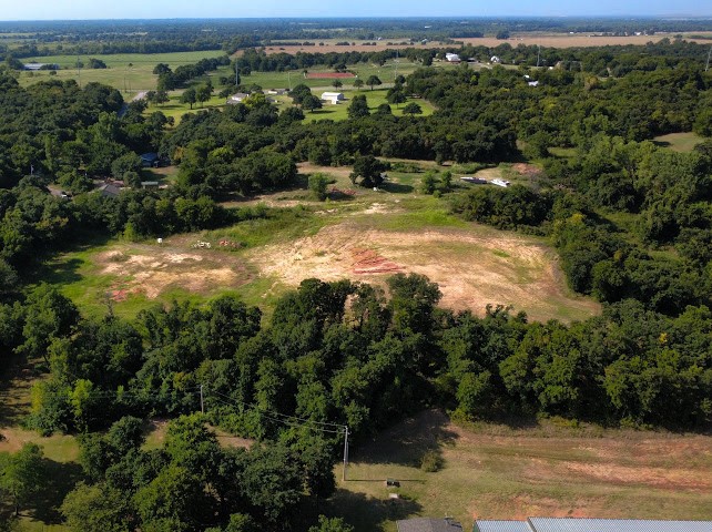 Pleasant Ridge Jones, OK 73049 - Photo 11 of 21 Expansive land parcel featuring a cleared building site, surrounded by mature trees