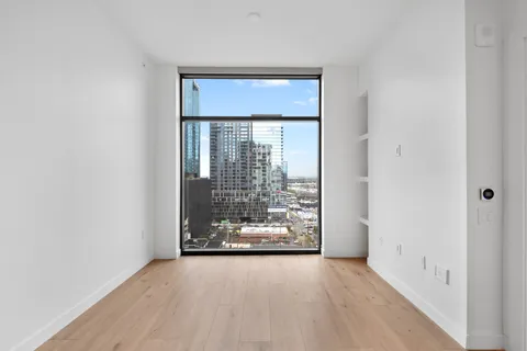 a kitchen with a refrigerator and white cabinets