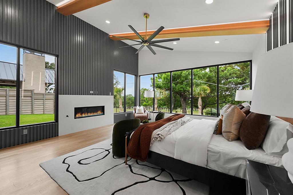 Vaulted ceiling with wood beam accents and recessed lighting