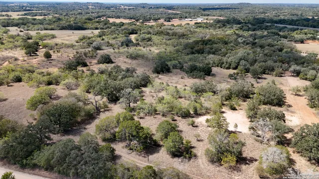 an aerial view of house with yard and mountain view