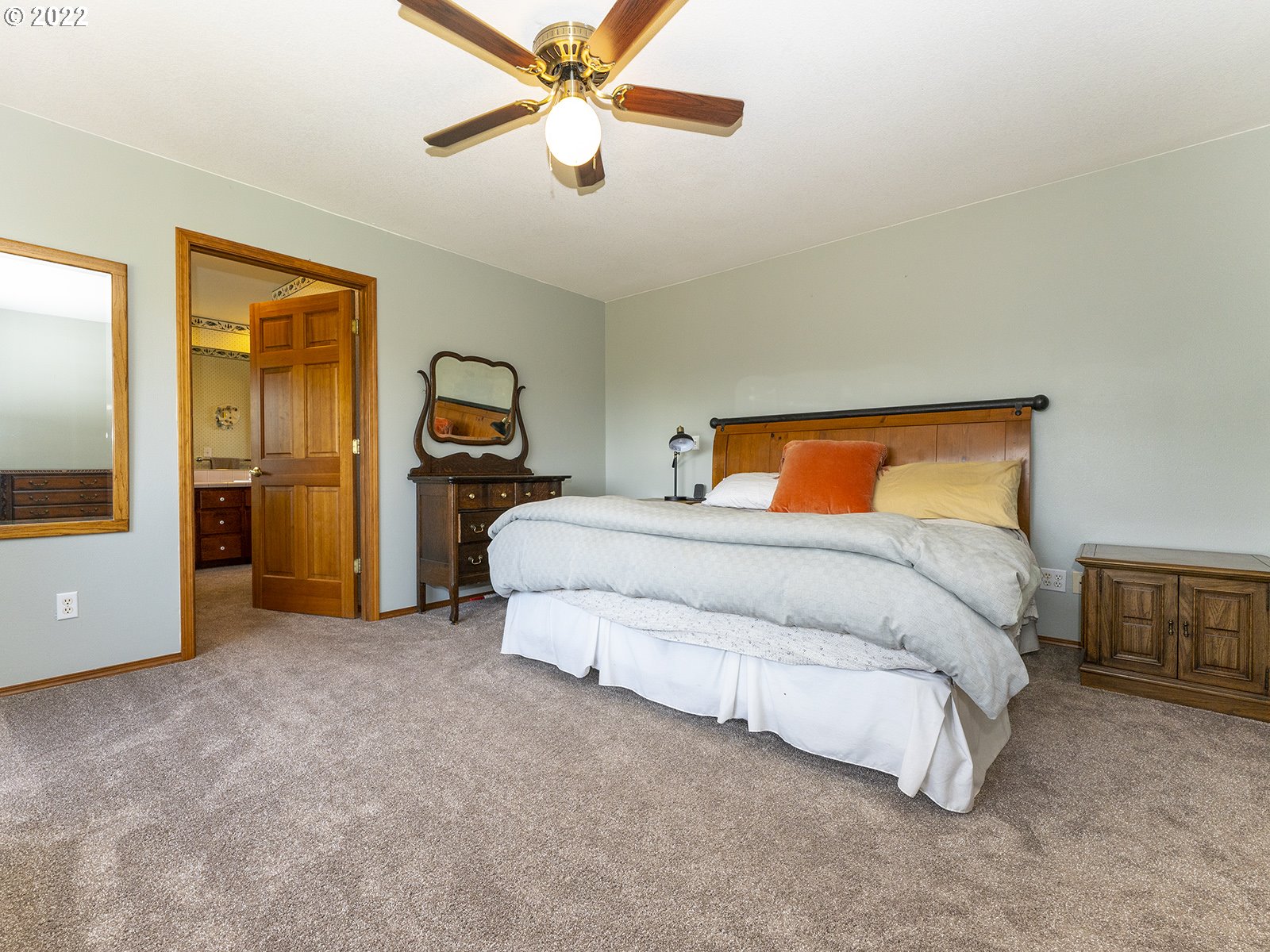 2286 South 31st Court Ridgefield, WA 98642 - Photo 14 of 31 a bedroom with a large bed and a chandelier