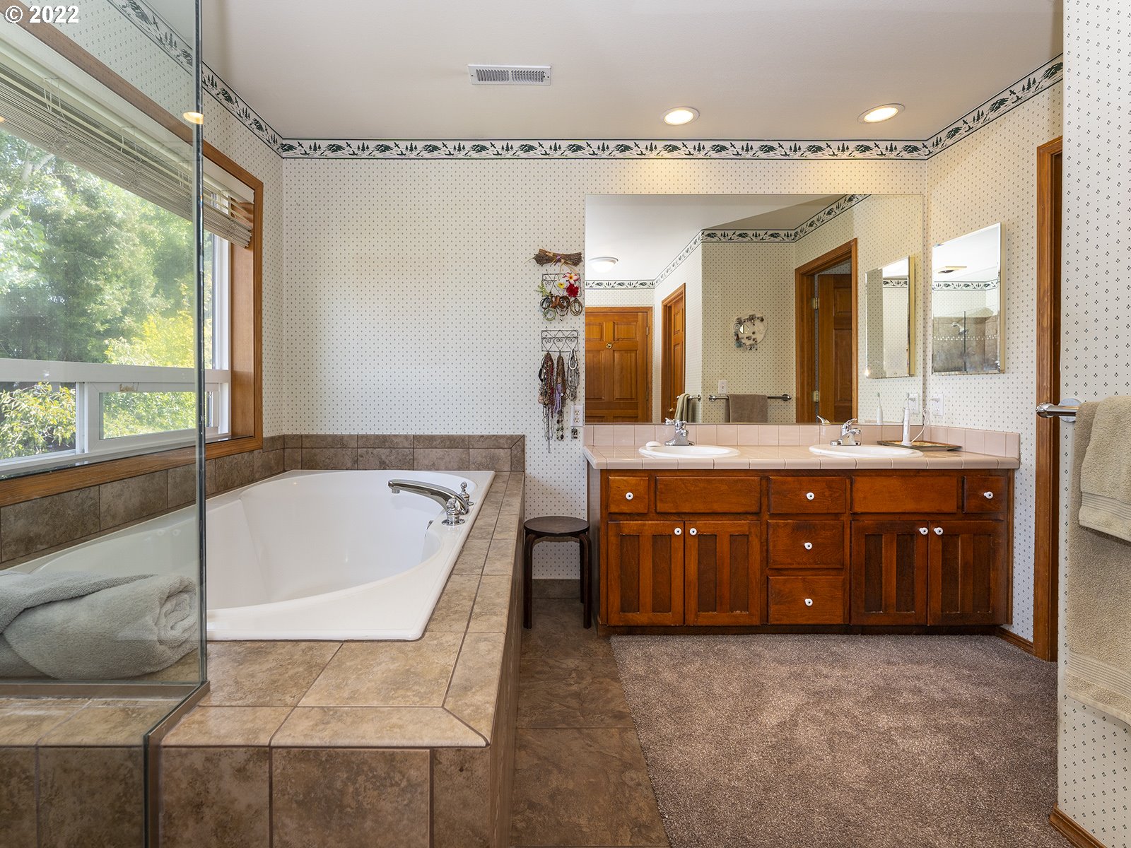 2286 South 31st Court Ridgefield, WA 98642 - Photo 18 of 31 a bathroom with a tub a double vanity sink and a large mirror