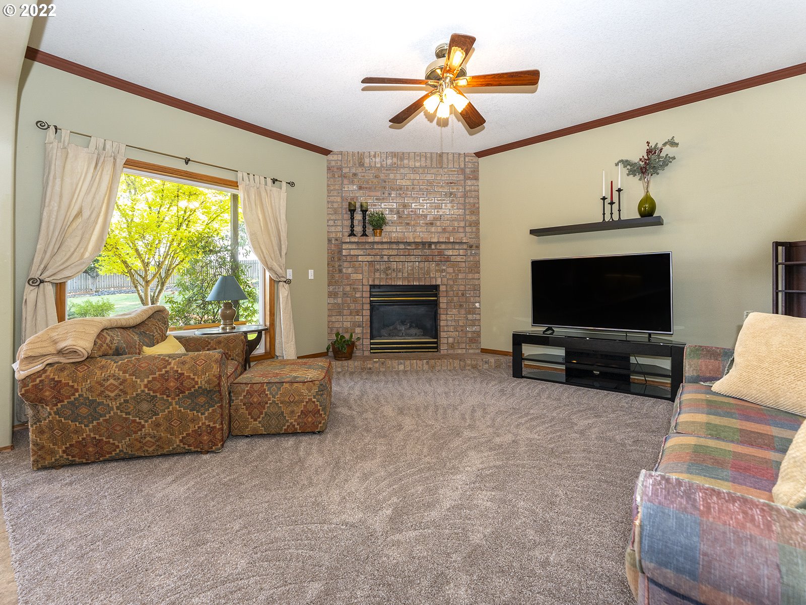 2286 South 31st Court Ridgefield, WA 98642 - Photo 5 of 31 a living room with furniture a flat screen tv and a fireplace